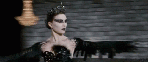 A Woman In A Black Dress And Crown Is Dancing . GIF