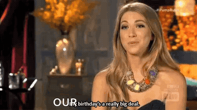 A Woman In A Black Dress And Necklace Is Talking About Her Birthday Being A Really Big Deal . GIF