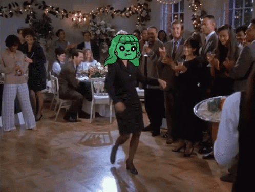 A Woman In A Black Dress Is Dancing In Front Of A Group Of People GIF