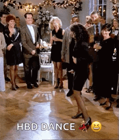 A Woman In A Black Dress Is Dancing On A Dance Floor At A Birthday Party . GIF