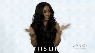 A Woman In A Black Dress Is Dancing With Her Arms Outstretched And Smiling . GIF