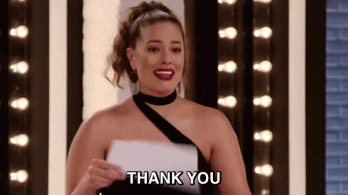 A Woman In A Black Dress Is Holding A Piece Of Paper And Says Thank You . GIF