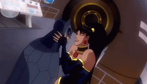 A Woman In A Black Dress Is Kissing A Man In A Black Suit In A Cartoon . GIF