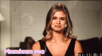 A Woman In A Black Dress Is Making A Funny Face And Says Mmmmhm Yea GIF