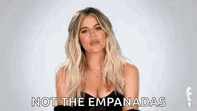 A Woman In A Black Dress Is Making A Funny Face And Says `` Not The Empanadas '' . GIF