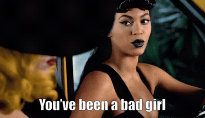 A Woman In A Black Dress Is Sitting In A Car With A Woman In A Yellow Hat . GIF