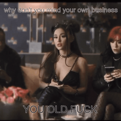 A Woman In A Black Dress Is Sitting On A Couch With The Caption " Why Don T You Mind Your Own Business You Old Fuck GIF