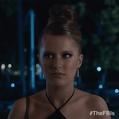 A Woman In A Black Dress Is Smiling And Has The Hashtag #Thefbls On Her Shoulder GIF