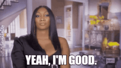 A Woman In A Black Dress Is Standing In A Living Room And Saying `` Yeah , I 'M Good '' . GIF