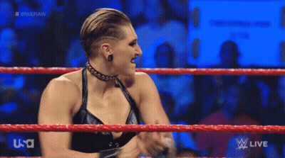 A Woman In A Black Dress Is Standing In A Wrestling Ring On Usa Network . GIF