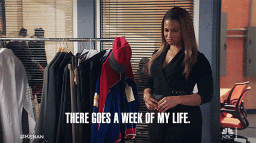 A Woman In A Black Dress Is Standing In Front Of A Rack Of Clothes And Says " There Goes A Week Of My Life " GIF