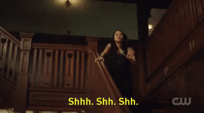 A Woman In A Black Dress Is Standing On A Set Of Stairs With The Words Sorority Initiation Thing Behind Her GIF