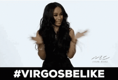 A Woman In A Black Dress Is Sticking Her Tongue Out While Dancing . GIF