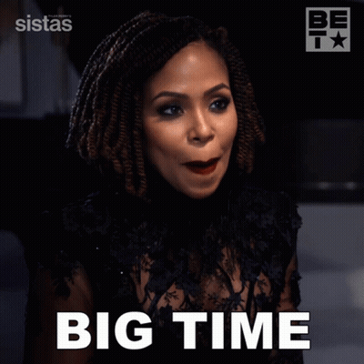 A Woman In A Black Dress Says " Big Time " In White Letters GIF