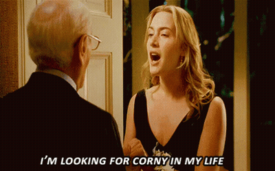 A Woman In A Black Dress Says I 'M Looking For Corny In My Life To A Man In A Suit GIF