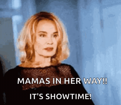A Woman In A Black Dress Says Mamas In Her Way ! It 'S Showtime ! GIF