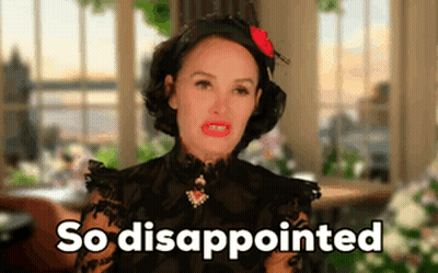 A Woman In A Black Dress Says So Disappointed In Front Of A Window GIF