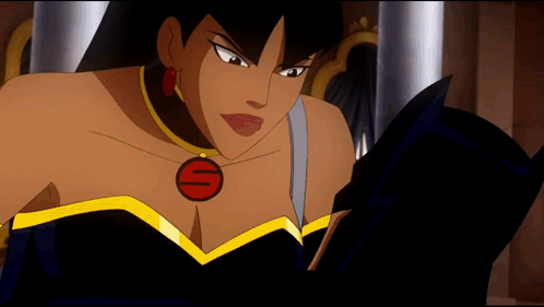 A Woman In A Black Dress With A Red S On Her Chest Is Reading A Book GIF