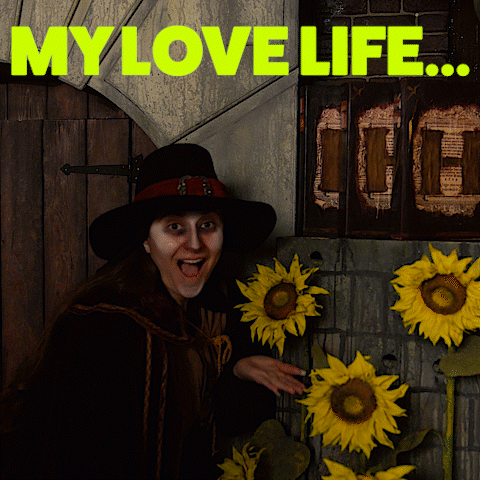A Woman In A Black Hat Stands In Front Of Sunflowers And The Words " My Love Life " Above Her GIF