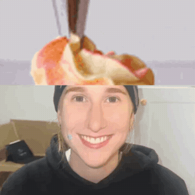 A Woman In A Black Hoodie Smiles In Front Of A Picture Of An Apple GIF