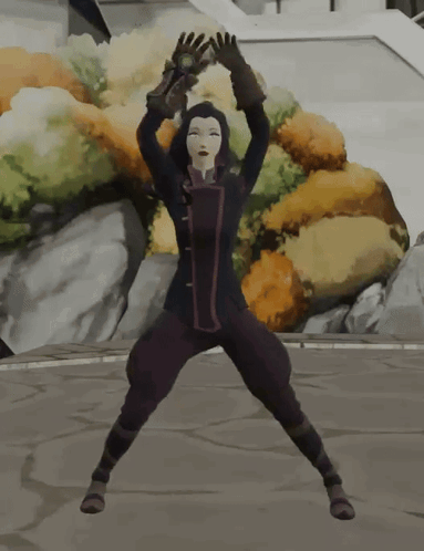 A Woman In A Black Jacket And Purple Pants Stands On Her Knees With Her Arms In The Air GIF