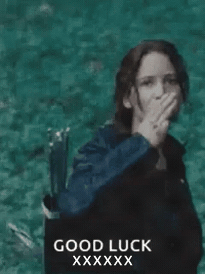 A Woman In A Black Jacket Is Giving The Middle Finger In Front Of The Ocean . GIF