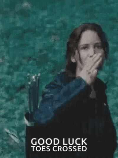 A Woman In A Black Jacket Is Giving The Middle Finger While Standing In Front Of A Body Of Water . GIF