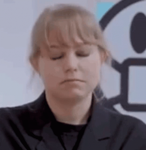A Woman In A Black Jacket Is Making A Sad Face . GIF