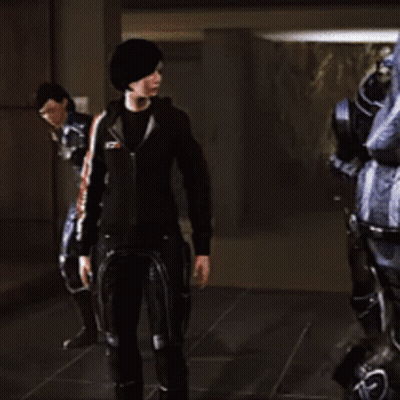 A Woman In A Black Jacket Is Standing In Front Of A Robot GIF
