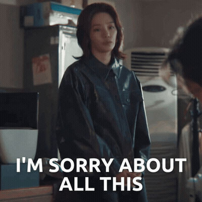 A Woman In A Black Jacket Says I 'M Sorry About All This In White Letters GIF