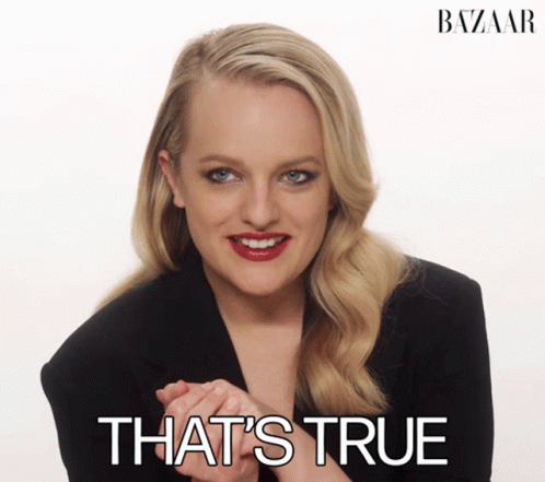 A Woman In A Black Jacket Smiles With The Words That 'S True Behind Her GIF