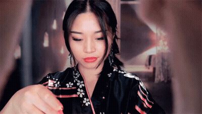 A Woman In A Black Kimono With Flowers On It GIF