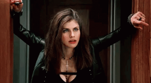 A Woman In A Black Leather Jacket Is Holding A Key In Her Hand . GIF