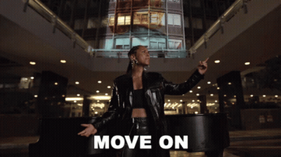A Woman In A Black Leather Jacket Stands In Front Of A Piano With The Words Move On Written Below Her GIF