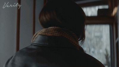 A Woman In A Black Leather Jacket With The Word Verity On The Bottom Right GIF