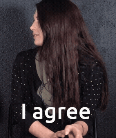A Woman In A Black Polka Dot Shirt Says I Agree GIF