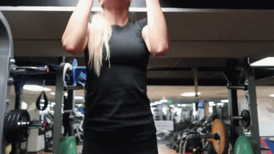 A Woman In A Black Shirt Is Doing A Pull Up GIF