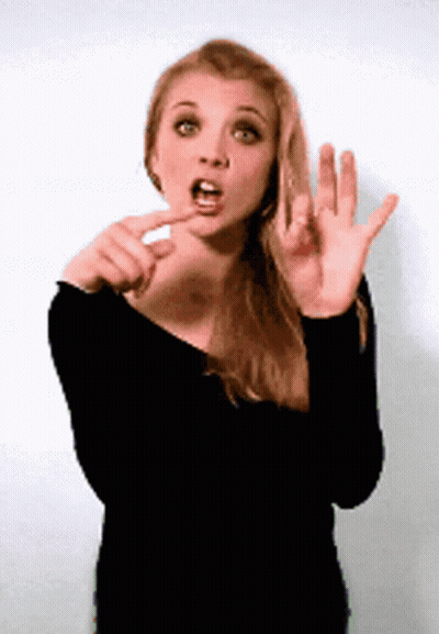 A Woman In A Black Shirt Is Making A Funny Face With Her Mouth Open GIF