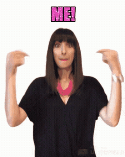 A Woman In A Black Shirt Is Pointing At Herself With The Word Me Above Her GIF