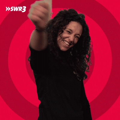 A Woman In A Black Shirt Is Smiling In Front Of A Red Circle With Swr3 Written On It GIF