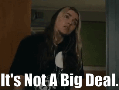 A Woman In A Black Shirt Is Standing In Front Of A Sign That Says `` It 'S Not A Big Deal '' . GIF