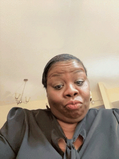 A Woman In A Black Shirt Making A Face GIF