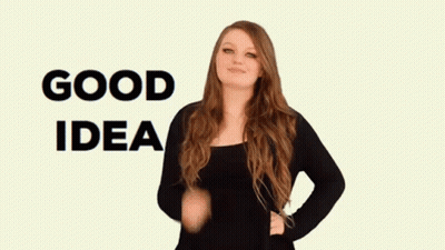 A Woman In A Black Shirt Says Good Idea In Sign Language GIF