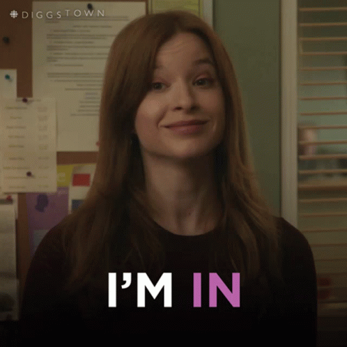 A Woman In A Black Shirt Says I 'M In In Pink Letters GIF