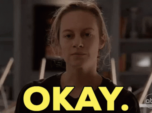 A Woman In A Black Shirt Says Okay GIF