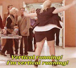 A Woman In A Black Skirt Is Running In Front Of A Group Of People With The Caption Vertical Running I 'M Vertical Runnin GIF