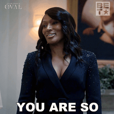 A Woman In A Black Suit Is Smiling And Says You Are So GIF