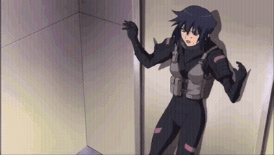 A Woman In A Black Suit Is Standing In A Room GIF