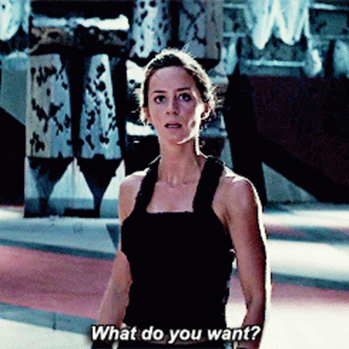 A Woman In A Black Tank Top Asks " What Do You Want " GIF
