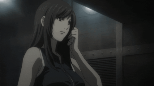 A Woman In A Black Tank Top Is Talking On A Cell Phone GIF